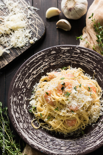 Pasta with shrimps in creamy garlic sauce photo