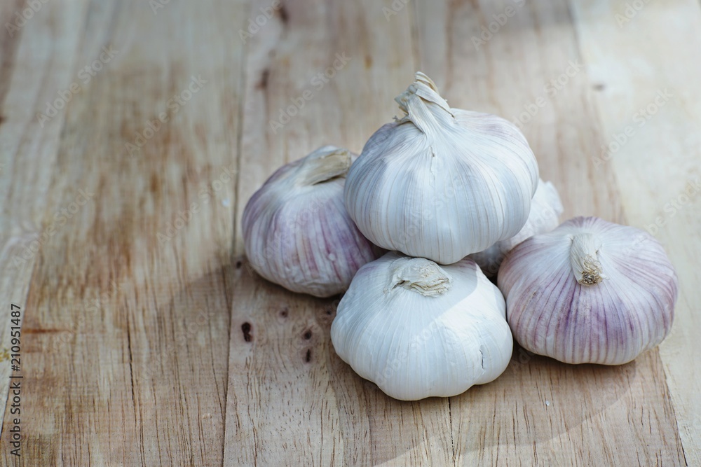 Fresh raw garlic on wooden table, copy space, kitchen raw ingredient concept Fresh raw garlic on wooden table, copy space, kitchen raw ingredient concept