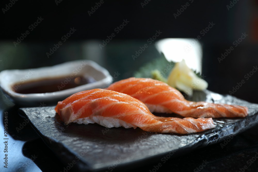 Salmon sushi on black plate japanese food Salmon sushi on black plate japanese food