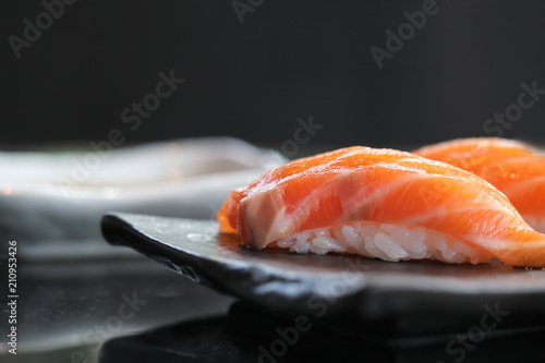Salmon sushi on black plate japanese food