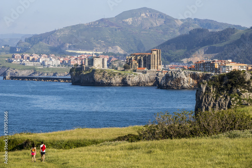 Castro Urdiales, Spain. Views of Santa Maria de la Asuncion Church and Castle of Santa Ana lighthouse from the Cementerio de Ballena photo