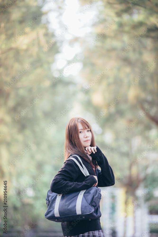 Portrait of asian japanese school girl costume looking at park outdoor film vintage style Portrait of asian japanese school girl costume looking at park outdoor film vintage style