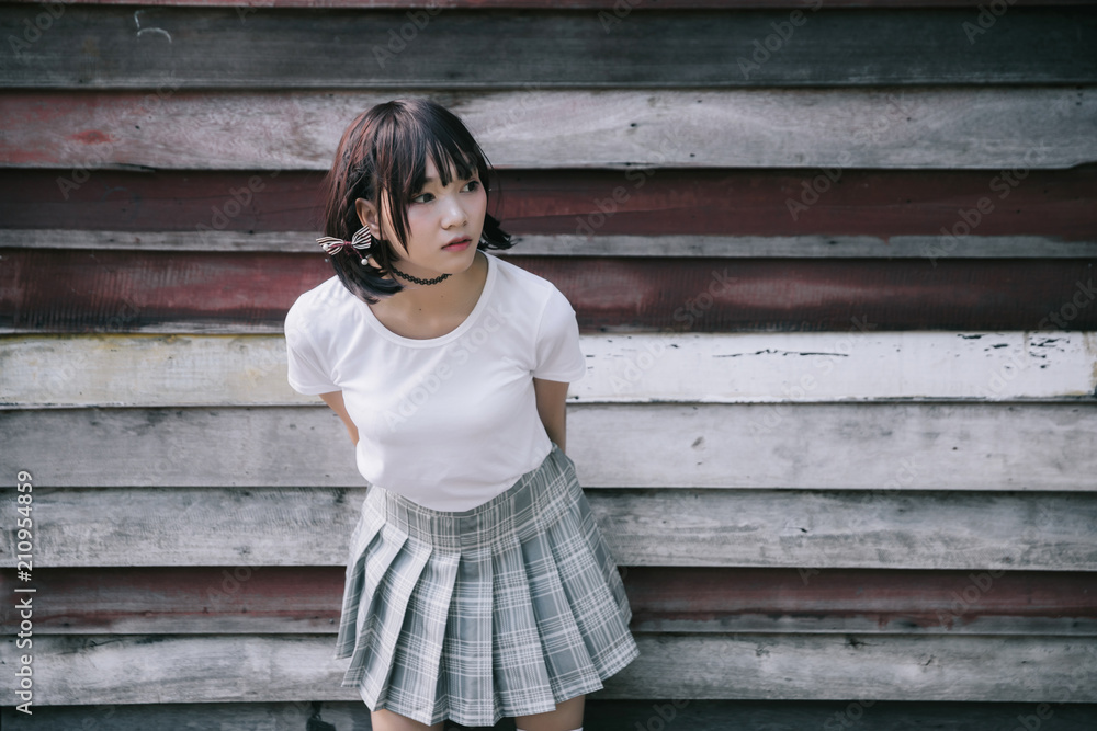 portrait of asian girl with white shirt and skirt looking in outdoor nature vintage film style portrait of asian girl with white shirt and skirt looking in outdoor nature vintage film style