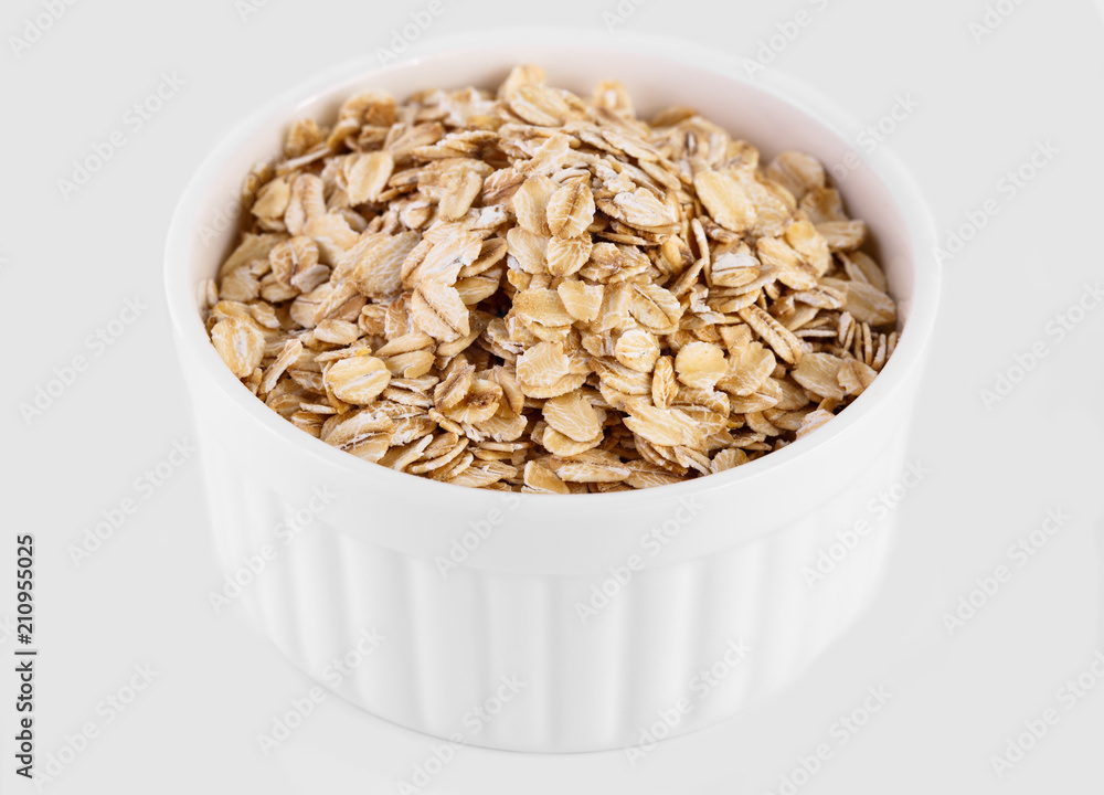 pile of oatmeal isolated on white background. Creative layout made of organic oatmeal isolated on white background. Food concept. pile of oatmeal isolated on white background. Creative layout made of organic oatmeal isolated on white background. Food concept.