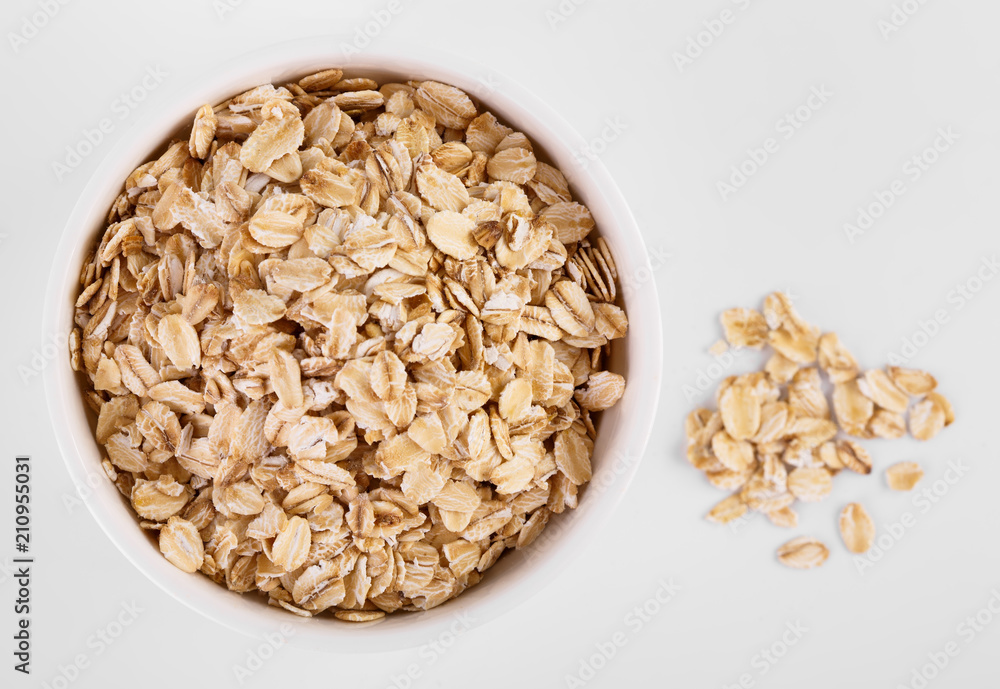 pile of oatmeal isolated on white background. Creative layout made of organic oatmeal isolated on white background. Food concept. pile of oatmeal isolated on white background. Creative layout made of organic oatmeal isolated on white background. Food concept.