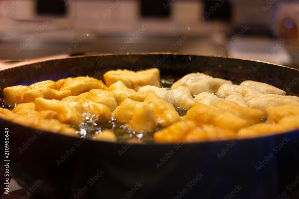 Selective focus deep fried dough stick in big pan,Traditional Thai street food Selective focus deep fried dough stick in big pan,Traditional Thai street food