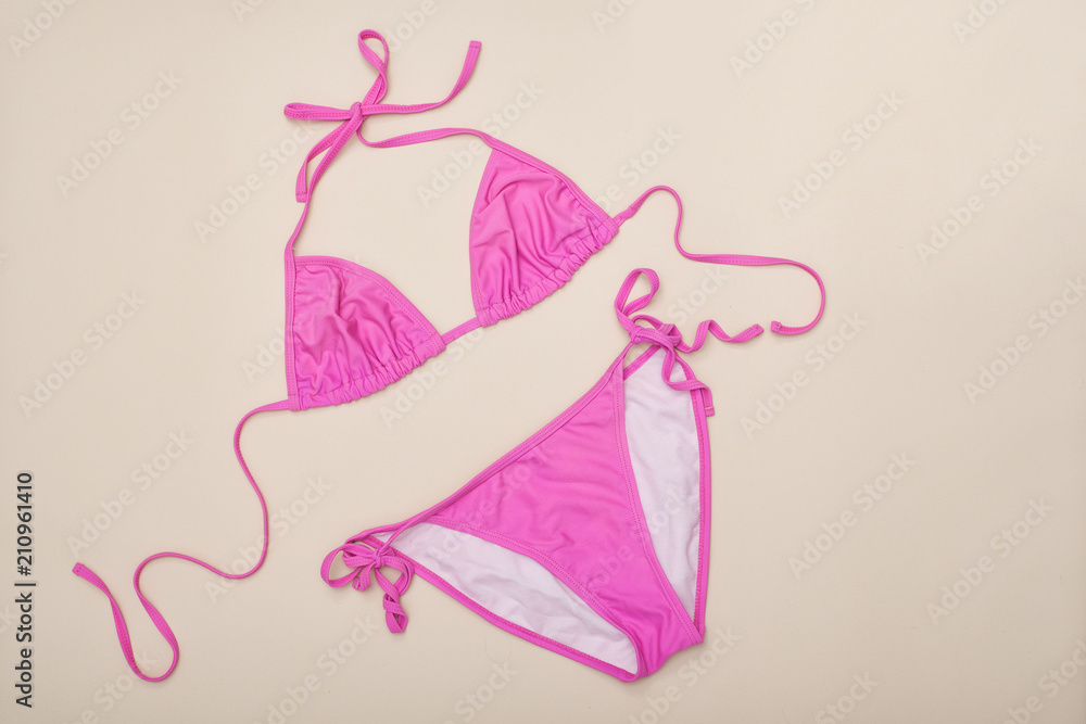 Pink swimsuit. Beach wardrobe. Fashionable concept Pink swimsuit. Beach wardrobe. Fashionable concept