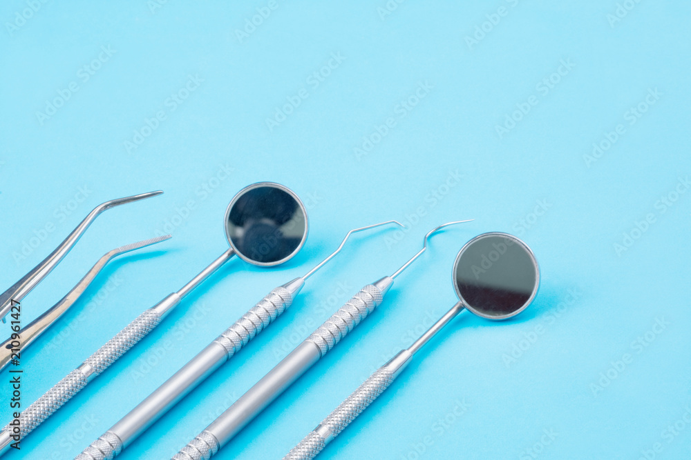 Dental tools use for dentist on the blue background, flat lay, top vipw. Dental tools use for dentist on the blue background, flat lay, top vipw.
