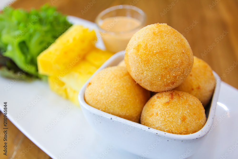 Fried cheese balls with pineapple ,lettuce and sauce. Fried cheese balls with pineapple ,lettuce and sauce.
