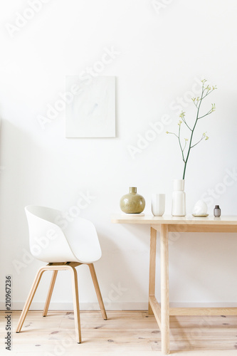 Living room setting with several vases displayed on a light wooden design table