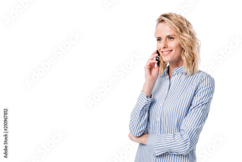 beautiful woman talking by smartphone and looking away isolated on white