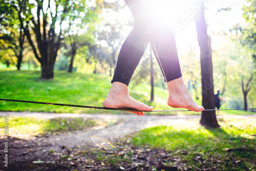 middle section human feet slacklining - balance, sport, tightrope concept photo