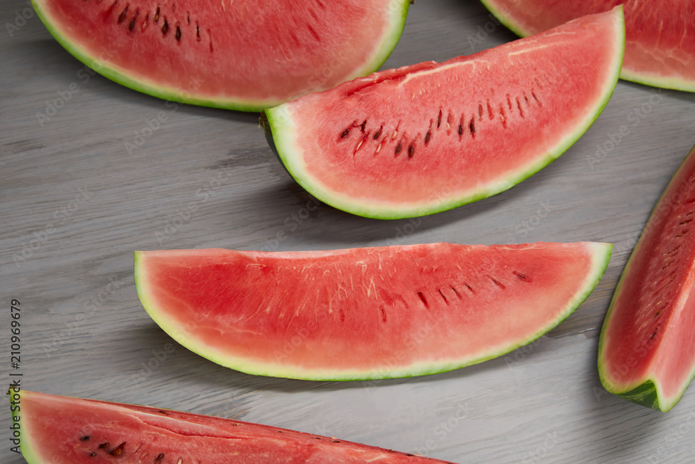 food composition with fresh watermelon slices on grey wooden surface