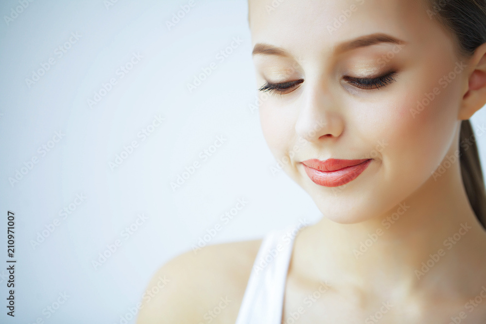 Naklejka premium Beauty and Care. Portrait of a Young Woman with a Beautiful Skin. Woman with Beautiful Blue Eyes. Cosmetics. Skin Care