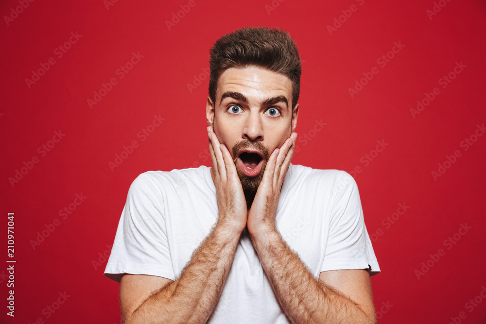 Portrait of a surprised young bearded man screaming loud Portrait of a surprised young bearded man screaming loud