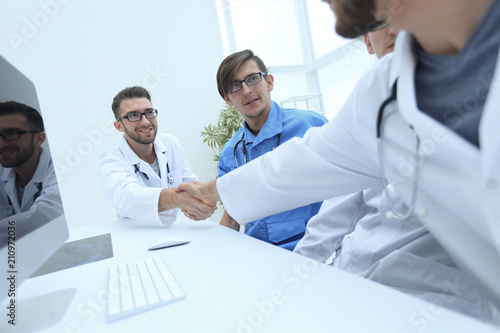 handshake between the two doctors during the working meeting