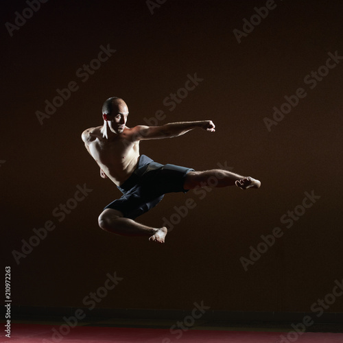 A kick to the side of an athlete beats in a high jump © andreyfire