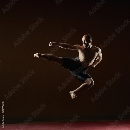 A man in a high jump beats a kick © andreyfire