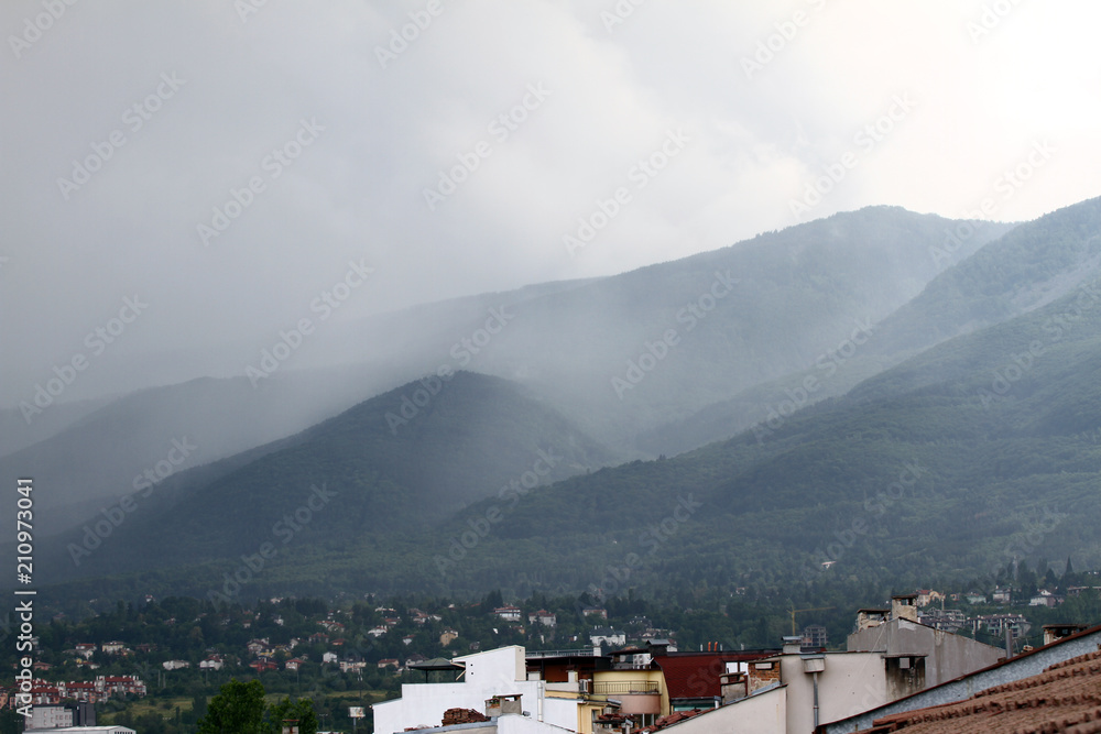 Heavy rain and a storm with damages on the Balkans in Europe. Rain and storm hail fall on the mountain. Thunder and lightning storm with rainfall. rainfall intensity. Bad weather concept. Rain shower.