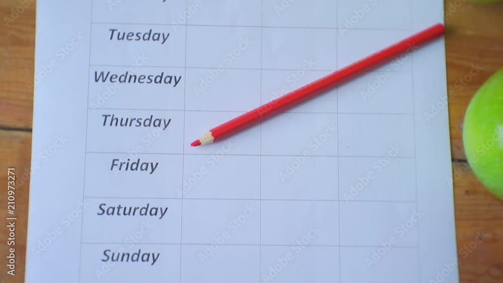 Diet plan. Camera moves and removes from above.Ripe green apples, blank empty diet plan and pencil lie on a wooden table. Diet plan. Camera moves and removes from above.Ripe green apples, blank empty diet plan and pencil lie on a wooden table.