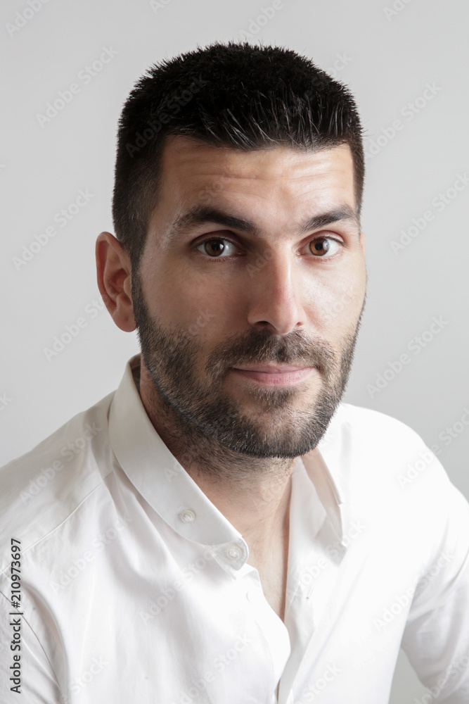 Portrait of young attractive bearded man, studio headshot Portrait of young attractive bearded man, studio headshot