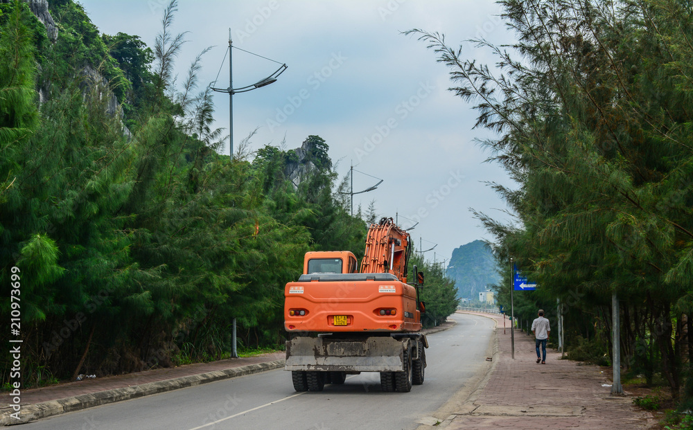 An excavator on street in Ha Long, Vietnam