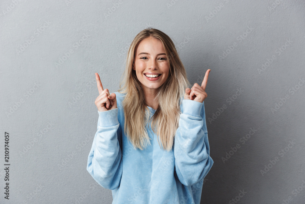 Portrait of a cheerful young girl in blue sweatshirt Portrait of a cheerful young girl in blue sweatshirt