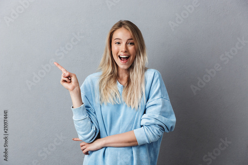 Portrait of an excited young girl in blue sweatshirt