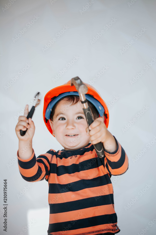 Little kid as a construction worker, hitting with a hammer