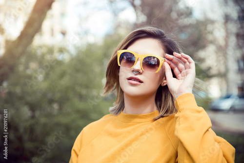 Young pierced woman wearing sunglasses