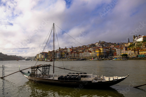 Porto, Portugal old town cityscape on the Douro River with traditional Rabelo boats.