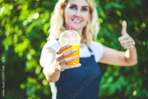 a girl drinks freshly squeezed juice, a healthy lifestyle
