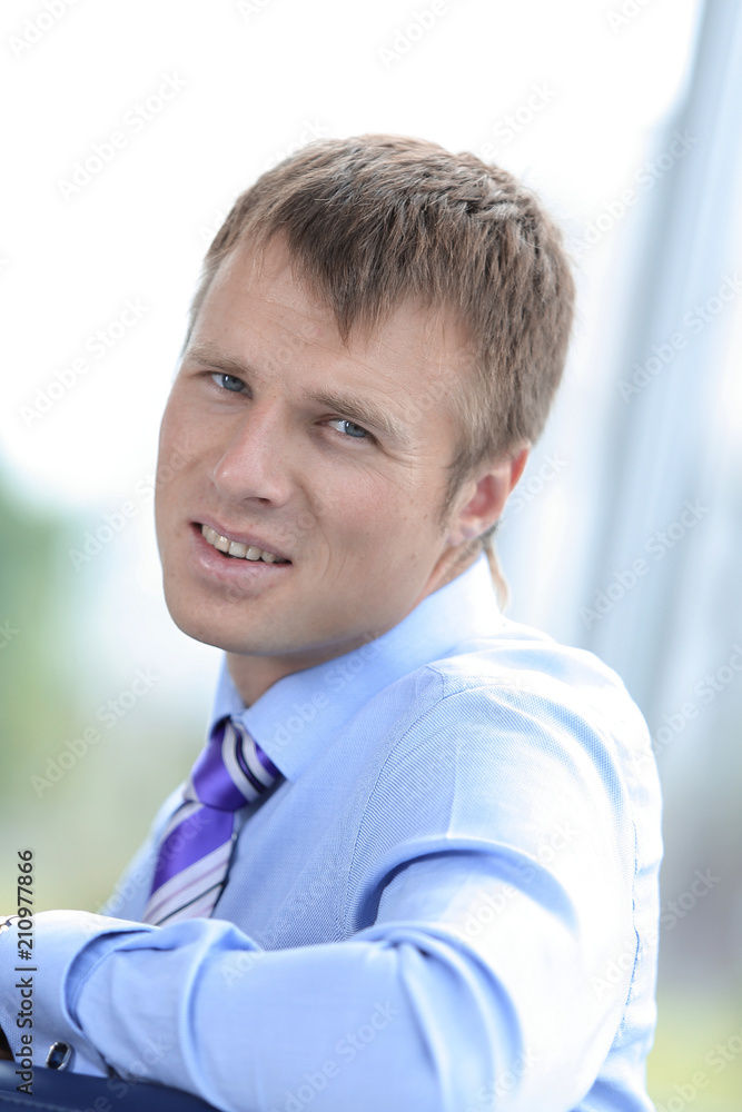 Confident businessman looking at camera, rear view Confident businessman looking at camera, rear view