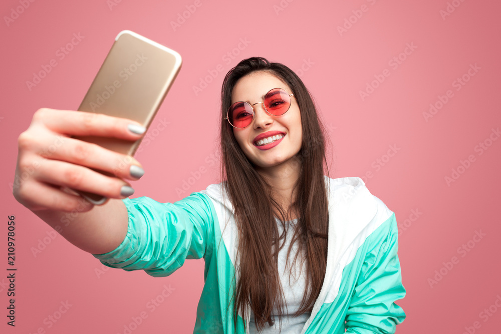Stylish hipster woman taking selfie