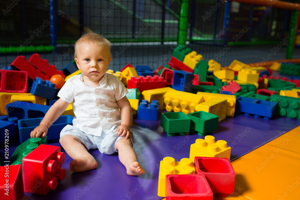 Little toddler child, playing in childrens playground indoors Little toddler child, playing in childrens playground indoors