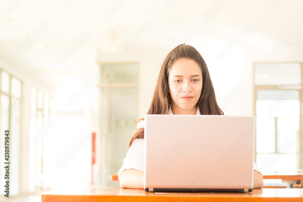 beautiful indian college girl using laptop (with selective focus) beautiful indian college girl using laptop (with selective focus)