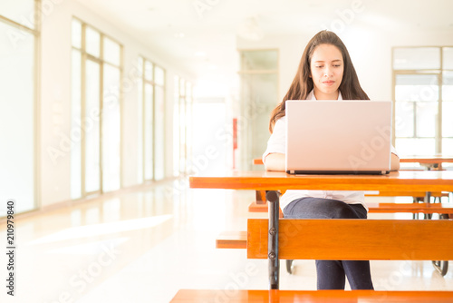 beautiful indian college girl using laptop (with selective focus)