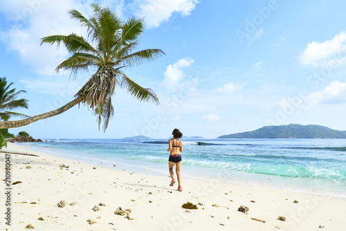 Running woman. Female runner jogging during outdoor workout on b