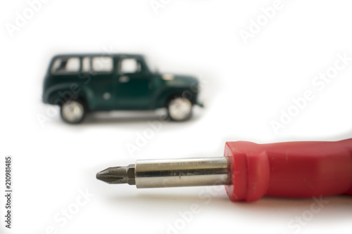 Car technician hands checking the air flow sensor with screwdriver in auto repair service.