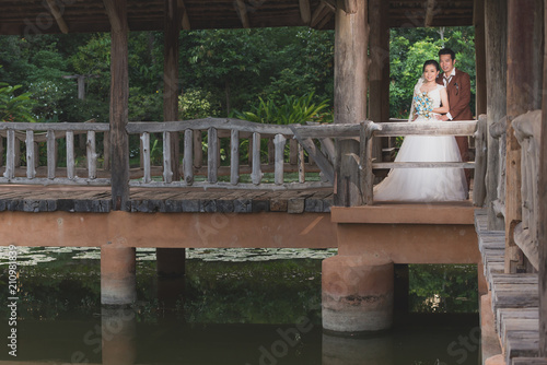 couple getting married shot outdoor in a field with selective focus and color tone adjust ment in post process