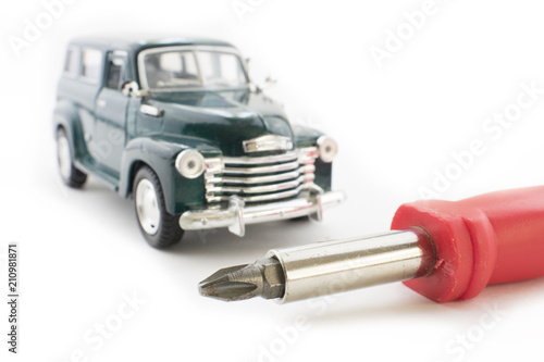Car technician hands checking the air flow sensor with screwdriver in auto repair service.