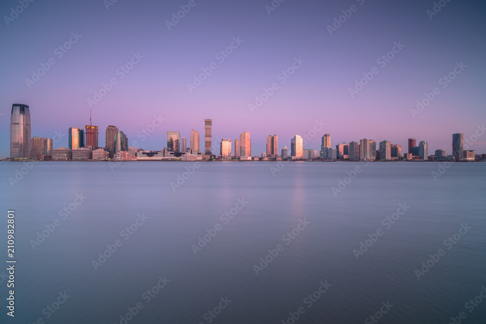 View on Jersey city from water during sunrise from