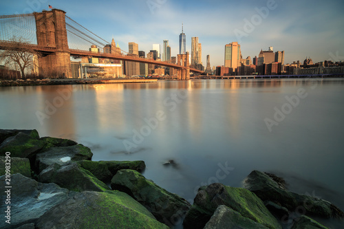 View on brooklyn bridge and manhattan from the rocks during sunrise