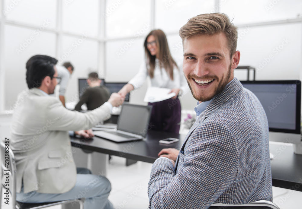 Fototapeta premium rear view. successful businessman sitting at his Desk