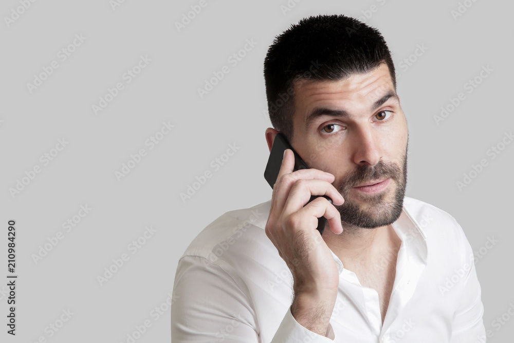 Portrait of young handsome businessman talking on mobile phone Portrait of young handsome businessman talking on mobile phone