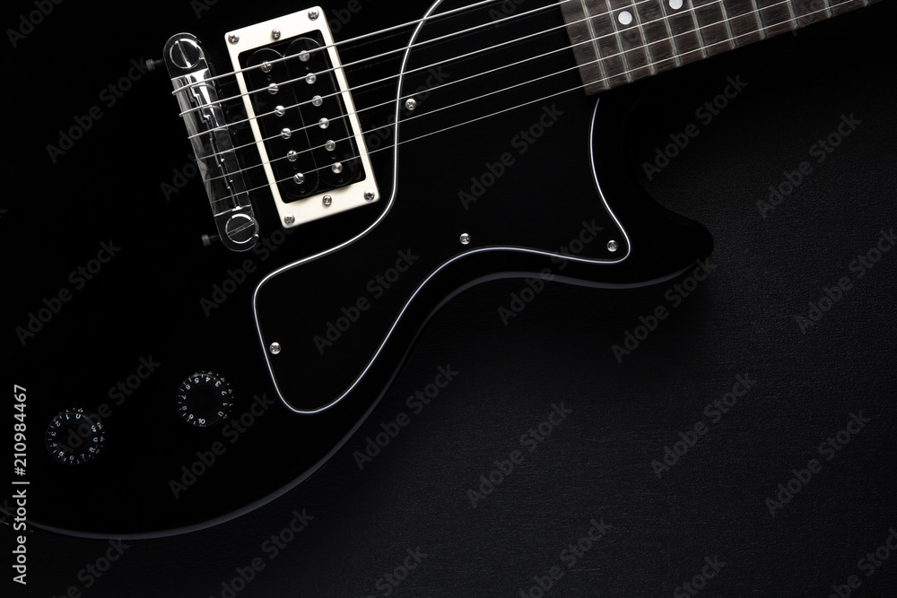 Fototapeta premium black electric guitar on a black