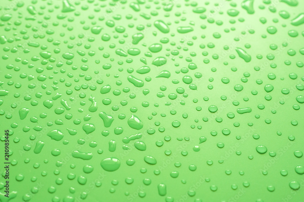 Water drops on green background.Close up of water droplets on green background.