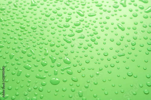 Water drops on green background.Close up of water droplets on green background.