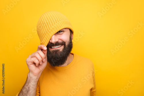 Handsome playful hipster in colorful hat photo