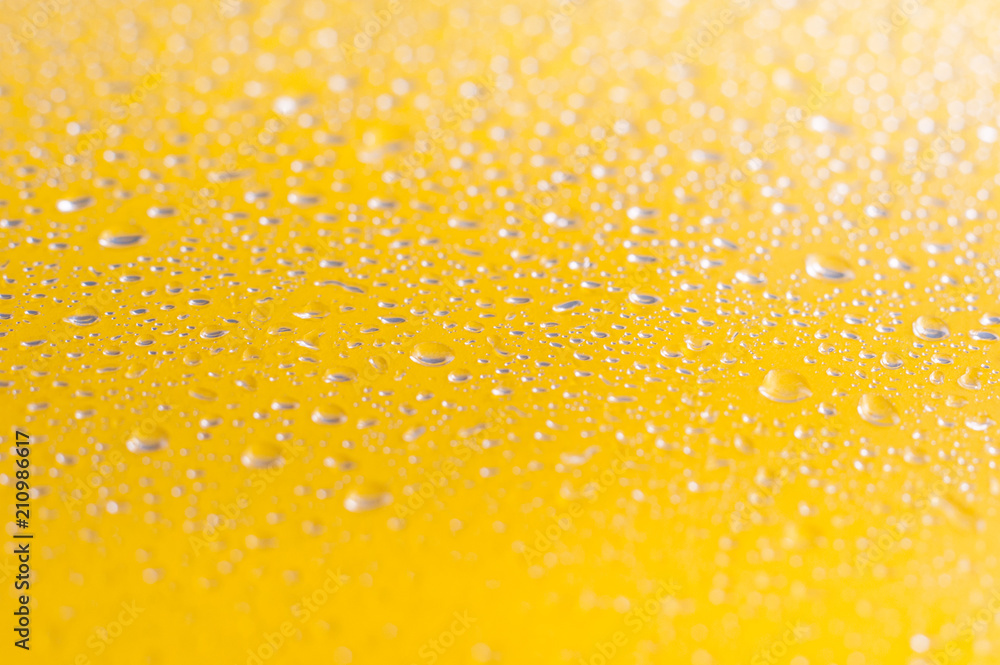 Water droplets on yellow background.